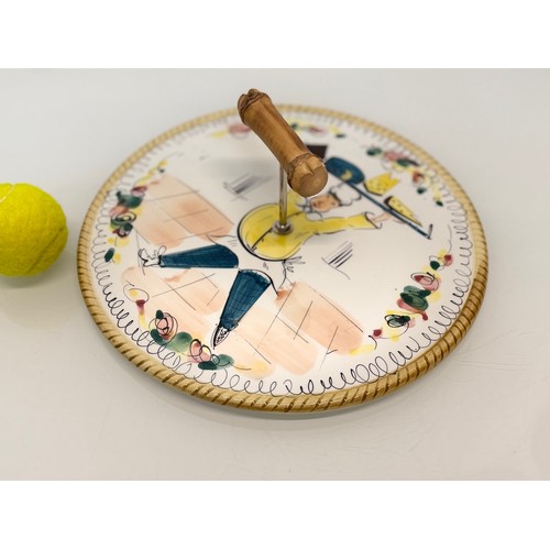 381 - Mid century table wares, a kitch serving platter decorated with an image of a jolly chef, 21 cm in d... 