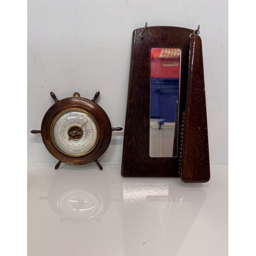 467 - A ships wheel mounted with a barometer and a hall mirror with a clothes brush attached.

This lot is... 