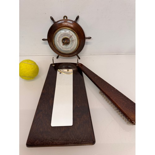 467 - A ships wheel mounted with a barometer and a hall mirror with a clothes brush attached.

This lot is... 