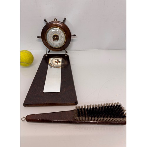467 - A ships wheel mounted with a barometer and a hall mirror with a clothes brush attached.

This lot is... 