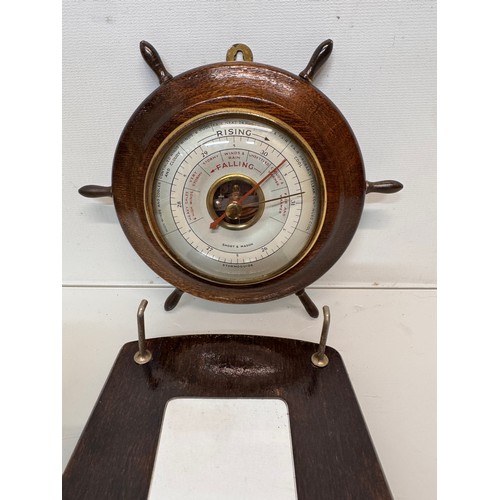 467 - A ships wheel mounted with a barometer and a hall mirror with a clothes brush attached.

This lot is... 