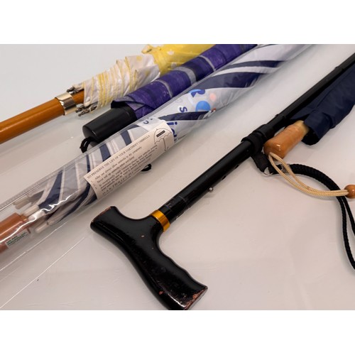 468 - A collection of umbrellas and a collapable walking stick.

This lot is available for in-house shippi... 