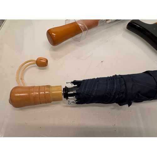 468 - A collection of umbrellas and a collapable walking stick.

This lot is available for in-house shippi... 