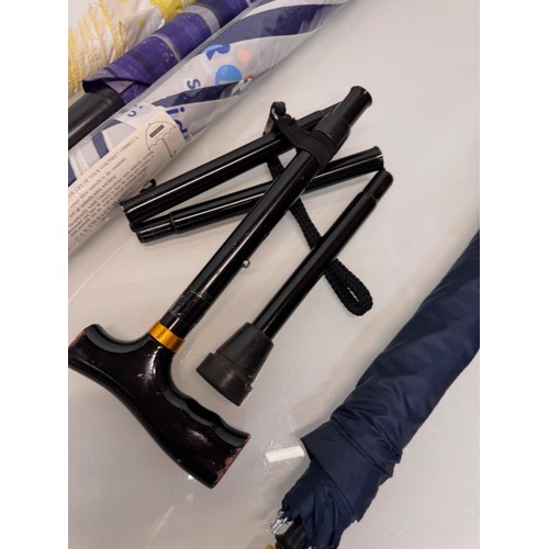 468 - A collection of umbrellas and a collapable walking stick.

This lot is available for in-house shippi... 