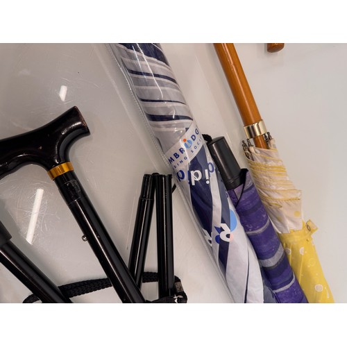 468 - A collection of umbrellas and a collapable walking stick.

This lot is available for in-house shippi... 