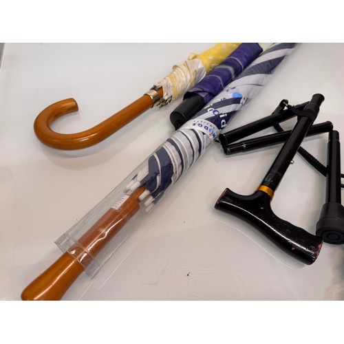 468 - A collection of umbrellas and a collapable walking stick.

This lot is available for in-house shippi... 