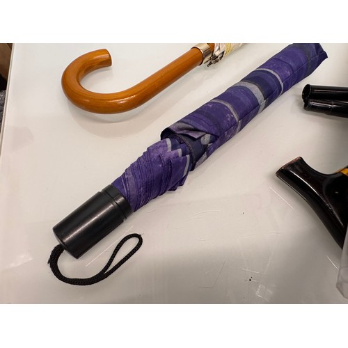 468 - A collection of umbrellas and a collapable walking stick.

This lot is available for in-house shippi... 