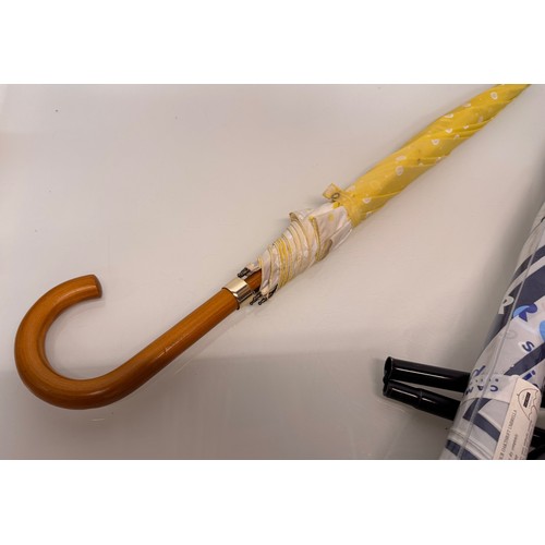 468 - A collection of umbrellas and a collapable walking stick.

This lot is available for in-house shippi... 
