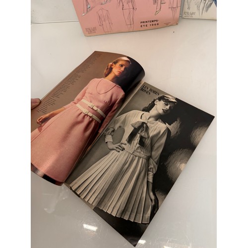 203 - Vintage Fashions, a manufactuers posters on board for 1960 ladies clothing, with a 1973 brochure.

T... 