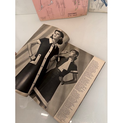 203 - Vintage Fashions, a manufactuers posters on board for 1960 ladies clothing, with a 1973 brochure.

T... 