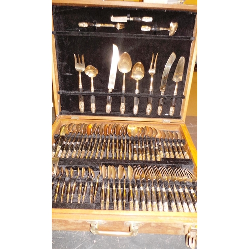 78 - BOXED 144 PIECE EBONY AND BRONZE BUDDHIST CUTLERY SET