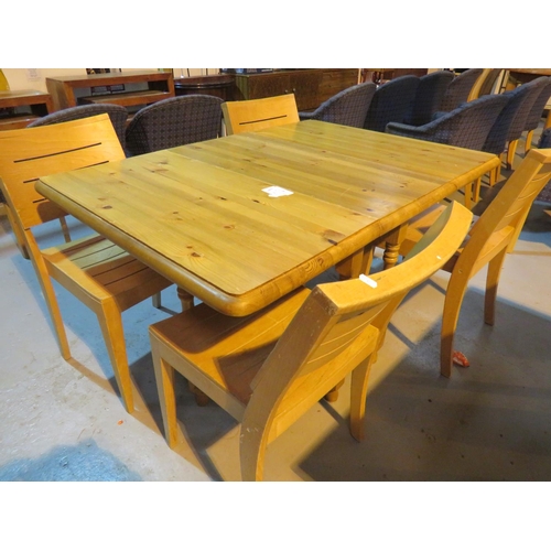 65 - A SOLID PINE TABLE AND FOUR ASSOCIATED CHAIRS