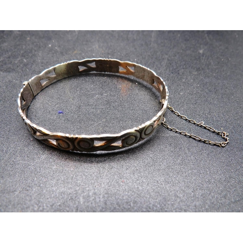 264 - STERLING SILVER PATTERED BANGLE - WITH CATCH FASTENER AND SAFETY CHAIN