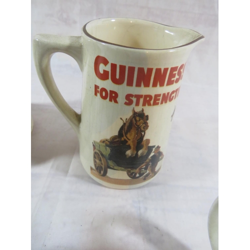 310 - FOUR GUINNESS ADVERTISING CUPS AND A GUINNESS JUG INCLUDES CARLTON WARE