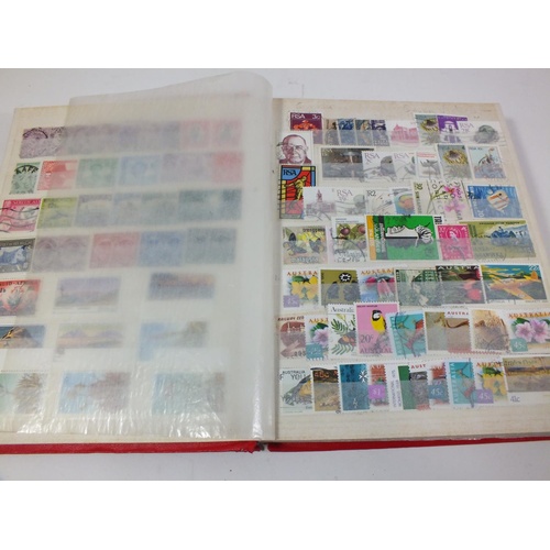 424 - RED STOCK BOOK WITH ESTIMATED 1500 STAMPS BRITISH/COMMONWEALTH