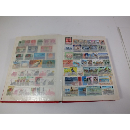 424 - RED STOCK BOOK WITH ESTIMATED 1500 STAMPS BRITISH/COMMONWEALTH