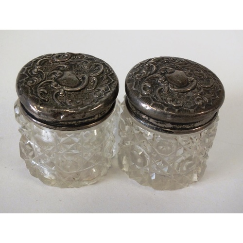 219 - A PAIR OF ANTIQUE CUT GLASS SOLID SILVER TOP DRESSING TABLE POTS, APPROX HEIGHT 4.5cm, LEVI & SALAMA... 