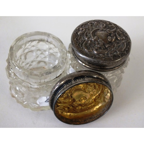 219 - A PAIR OF ANTIQUE CUT GLASS SOLID SILVER TOP DRESSING TABLE POTS, APPROX HEIGHT 4.5cm, LEVI & SALAMA... 