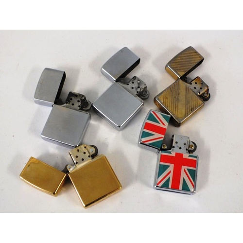 316 - FOUR ZIPPO PETROL LIGHTERS AND A UNION JACK ZIPPO STYLE PETROL LIGHTER