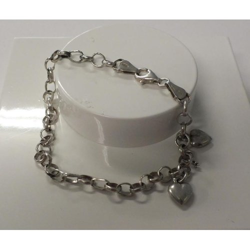 235 - STERLING SILVER CURB LINK BRACELET WITH TWO SILVER HEART CHARMS