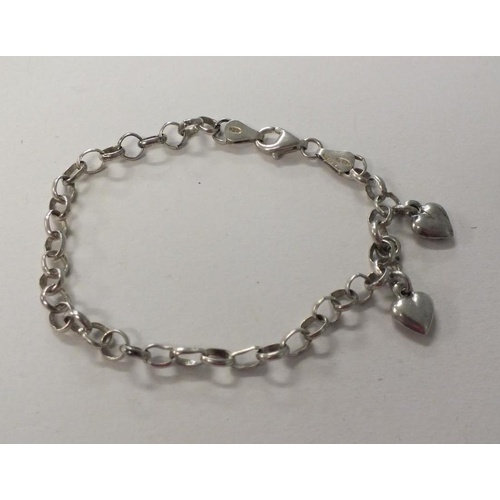 235 - STERLING SILVER CURB LINK BRACELET WITH TWO SILVER HEART CHARMS