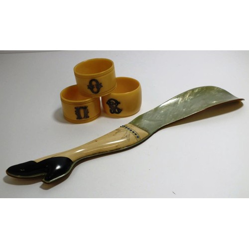 389 - 1940's BAKELITE SHOE HORN AND THREE NAPKIN RINGS WITH SILVER INITIALS