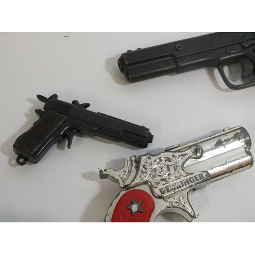 352 - ELEVEN VINTAGE MINIATURE CAP GUNS AND KEYRINGS