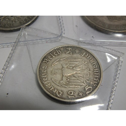 391 - THREE FOREIGN SILVER COINS