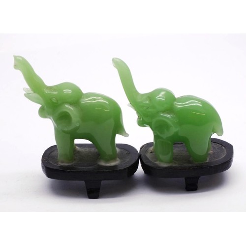 359 - PAIR OF SMALL CARVED JADE ELEPHANTS ON WOODEN PLINTHS