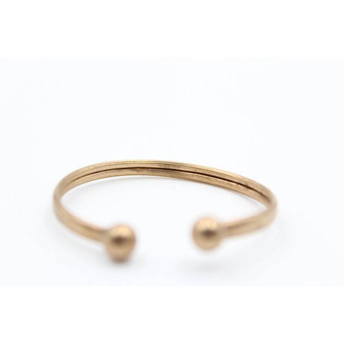 98 - 9ct Gold childs torque bangle (1.7g)