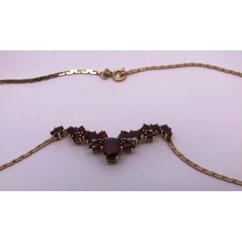 208 - 9ct GOLD CHAIN SET WITH GARNETS. 7g