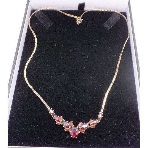 208 - 9ct GOLD CHAIN SET WITH GARNETS. 7g