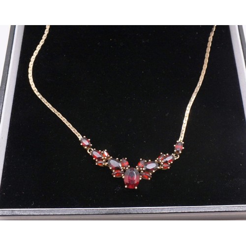 208 - 9ct GOLD CHAIN SET WITH GARNETS. 7g