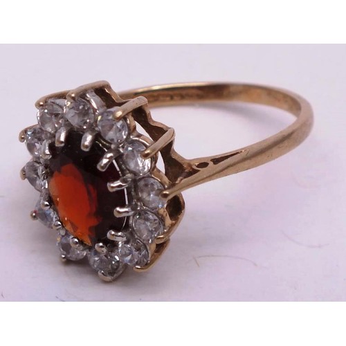 251 - 9CT GOLD RING RED STONE & CLEAR, SIZE K. 1g