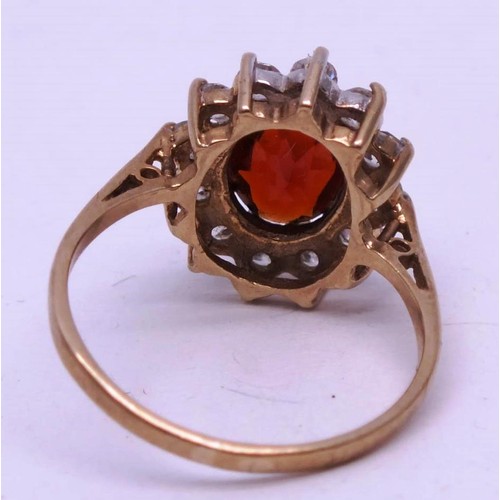 251 - 9CT GOLD RING RED STONE & CLEAR, SIZE K. 1g