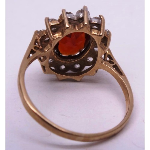 251 - 9CT GOLD RING RED STONE & CLEAR, SIZE K. 1g