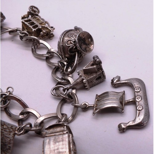 253 - SILVER CHARM BRACELET WITH NINE SILVER CHARMS