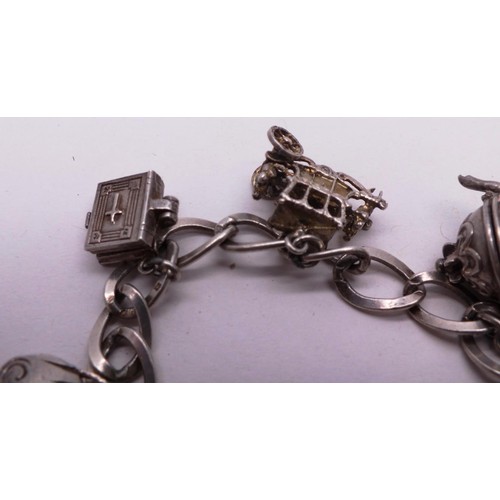 253 - SILVER CHARM BRACELET WITH NINE SILVER CHARMS