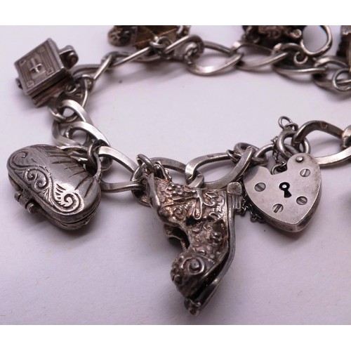 253 - SILVER CHARM BRACELET WITH NINE SILVER CHARMS