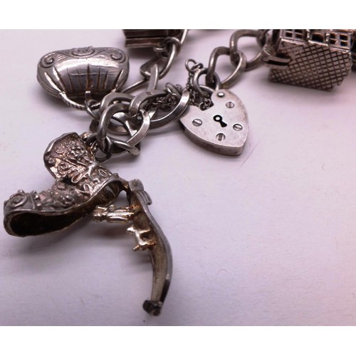 253 - SILVER CHARM BRACELET WITH NINE SILVER CHARMS