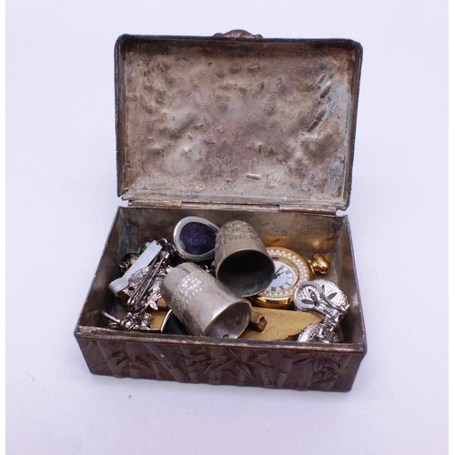 324 - VINTAGE ORIENTAL METAL RELIEF TIN WITH PAGODA AND CONTENTS INCLUDES JEWELERY, THIMBLES etc