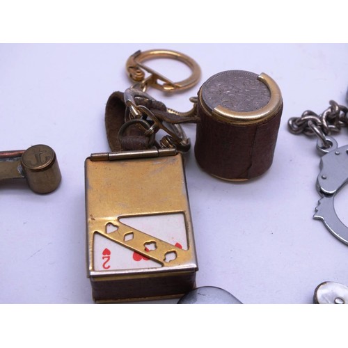 328 - EIGHT VINTAGE KEYRINGS INCLUDES SIXPENCE HOLDER WITH SIXPENCES, BOSUNS WHISTLE, PENKNIVES AND CUFFLI... 