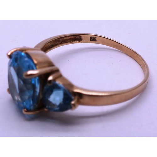 402 - 9CT GOLD LADIES RING WITH THREE LARGE BLUE STONES - SIZE O- 2.42G