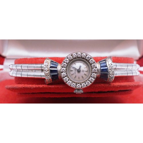 418 - 18CT WHITE GOLD LADIES OMEGA WATCH BOXED WITH SAPPHIRES AND DIAMONDS