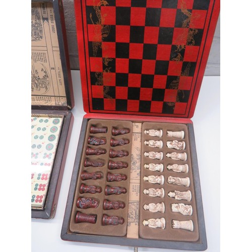 121 - TWO ORIENTAL FOLD UP GAME SETS - CHESS AND MAHJONG