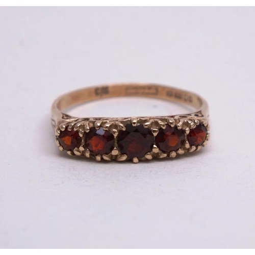 309 - 9CT GOLD RING WITH FIVE RED STONES