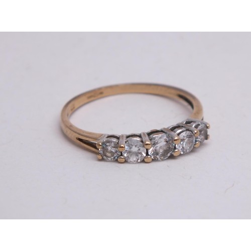 311 - 9CT GOLD RING WITH FIVE CZ STONES