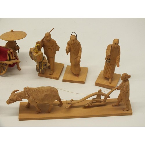 391 - BOX OF HAND CARVED WOODEN ORIENTAL FIGURES