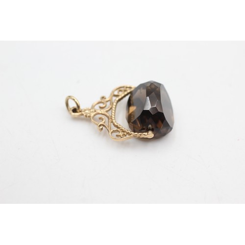 486 - 9ct gold smokey quartz spinner fob (7g)