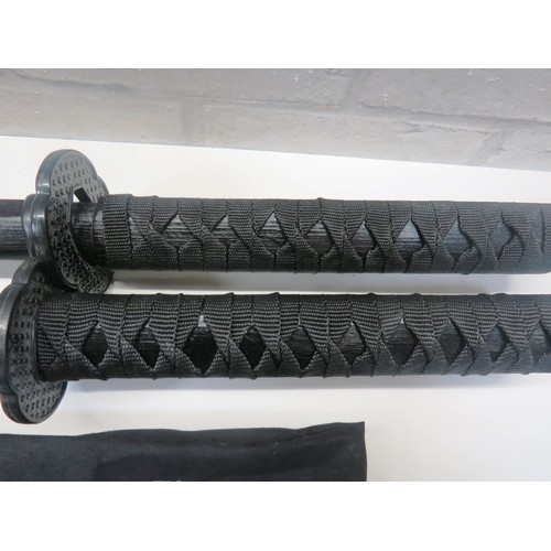 24 - TWO WOODEN KATANAS WITH CARRY CASE